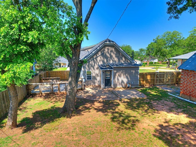 908 N Barta Ave, Prague, OK 74864 - rear view of house with a fenced backyard