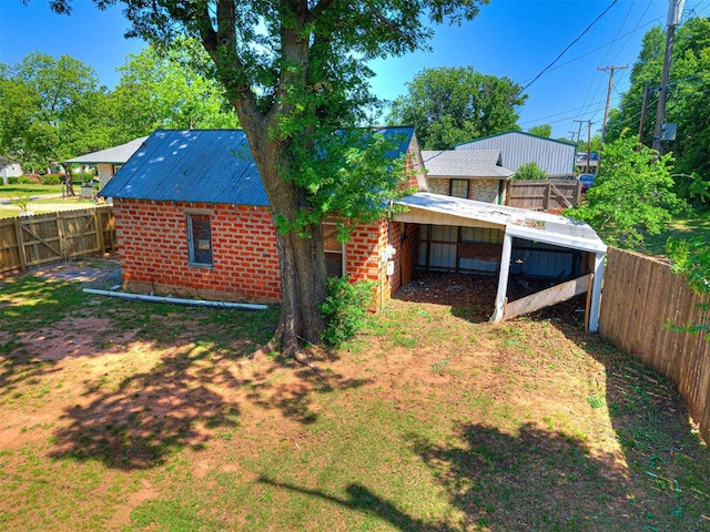908 N Barta Ave, Prague, OK 74864 - back of property featuring a fenced backyard and brick siding