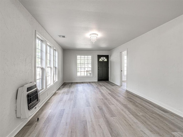 908 N Barta Ave, Prague, OK 74864 - foyer entrance with heating unit, wood finished floors, a textured wall, and baseboards