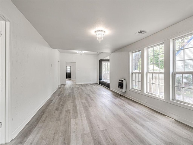 908 N Barta Ave, Prague, OK 74864 - unfurnished living room featuring light wood-style floors, healthy amount of natural light, heating unit, and baseboards