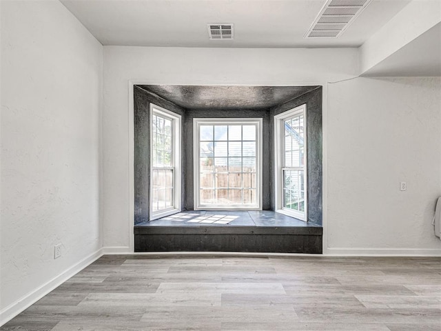 908 N Barta Ave, Prague, OK 74864 - unfurnished room with healthy amount of natural light, wood finished floors, baseboards, and a textured wall