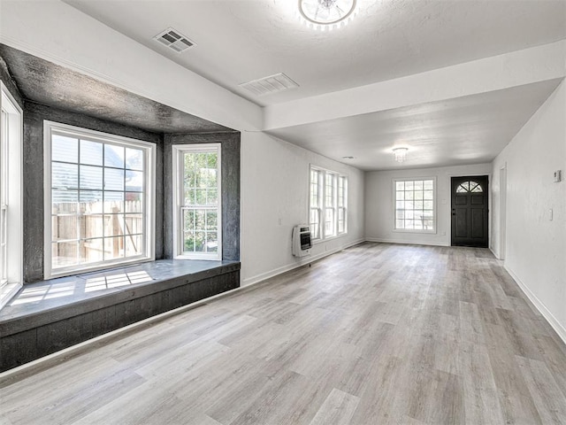 908 N Barta Ave, Prague, OK 74864 - unfurnished living room featuring heating unit, wood finished floors, and baseboards