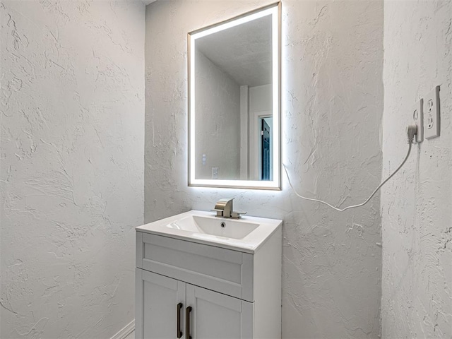 908 N Barta Ave, Prague, OK 74864 - bathroom featuring vanity and a textured wall