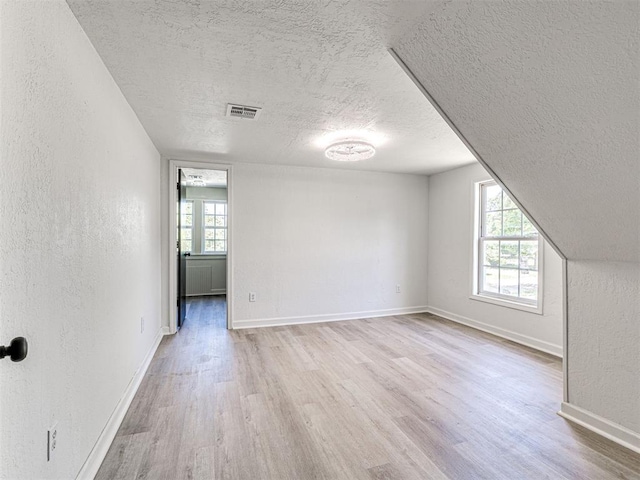 908 N Barta Ave, Prague, OK 74864 - interior space with a textured ceiling, wood finished floors, a textured wall, and baseboards