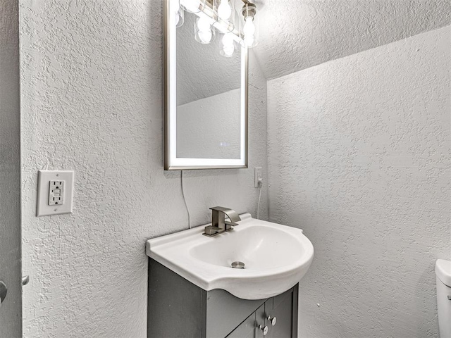 908 N Barta Ave, Prague, OK 74864 - bathroom with vanity, a textured wall, and toilet