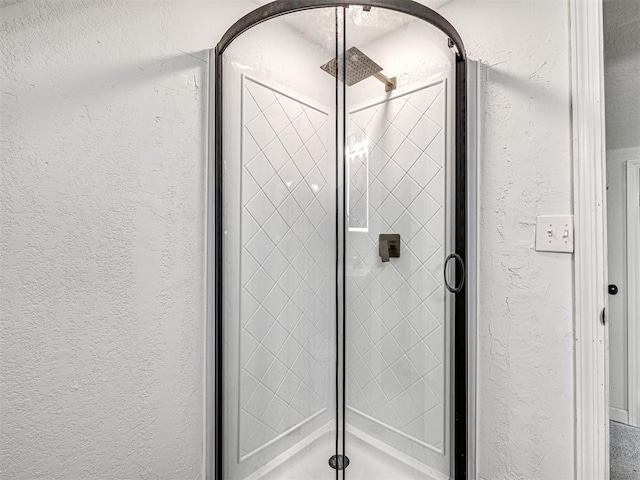 908 N Barta Ave, Prague, OK 74864 - bathroom featuring a textured wall and a stall shower