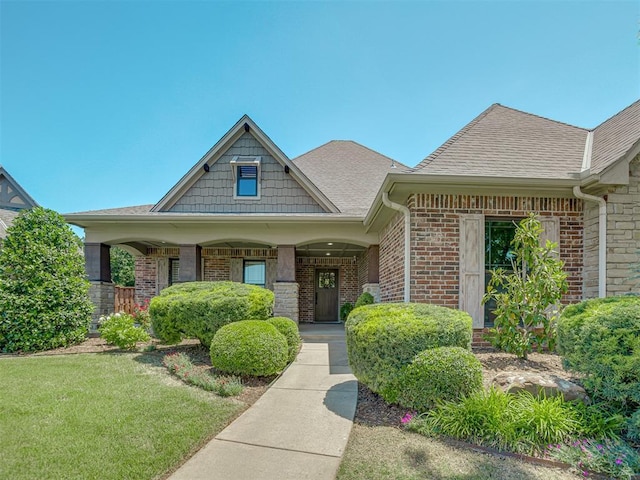 4300 High Range Ln, Edmond, OK 73034 - view of front facade featuring brick siding, roof with shingles, and a front lawn