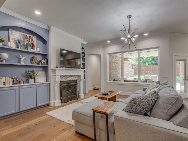 4300 High Range Ln, Edmond, OK 73034 - living area featuring ornamental molding, a chandelier, light wood finished floors, a tiled fireplace, and recessed lighting
