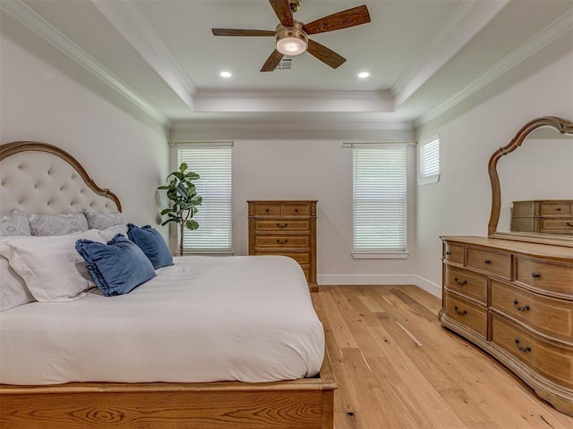 4300 High Range Ln, Edmond, OK 73034 - bedroom featuring a tray ceiling, light wood-style floors, crown molding, baseboards, and ceiling fan