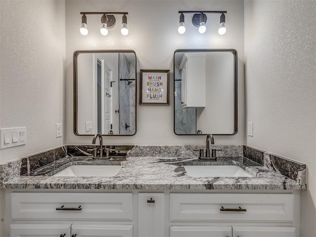 4300 High Range Ln, Edmond, OK 73034 - bathroom with double vanity, a textured wall, and a shower