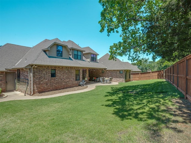 4300 High Range Ln, Edmond, OK 73034 - rear view of house with brick siding, a patio, and roof with shingles