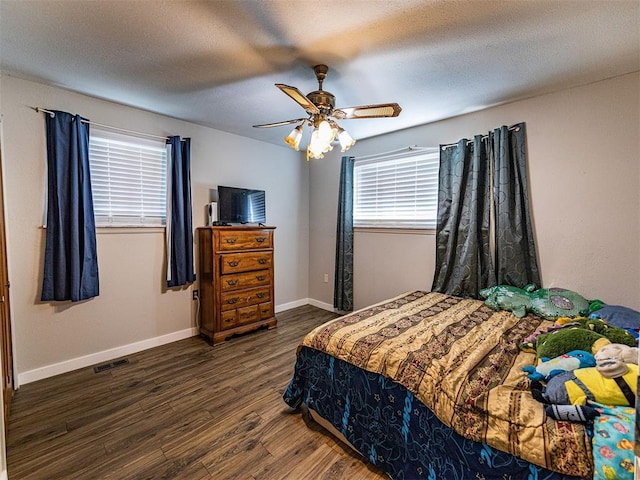 1515 S Reno Ave, El Reno, OK 73036 - bedroom with wood finished floors, a ceiling fan, and baseboards