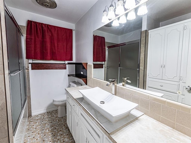 1515 S Reno Ave, El Reno, OK 73036 - bathroom with toilet, vanity, decorative backsplash, and tile patterned floors