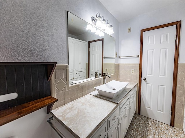 1515 S Reno Ave, El Reno, OK 73036 - bathroom with tile walls, tile patterned floors, vanity, and a wainscoted wall