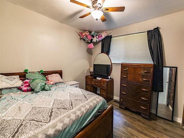 1515 S Reno Ave, El Reno, OK 73036 - bedroom with dark wood-type flooring, baseboards, ceiling fan, and a textured ceiling