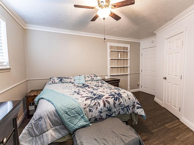 1515 S Reno Ave, El Reno, OK 73036 - bedroom with a textured ceiling, wood finished floors, crown molding, a ceiling fan, and wainscoting