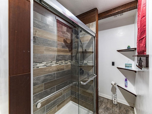 1515 S Reno Ave, El Reno, OK 73036 - bathroom with a stall shower, wood finished floors, and baseboards