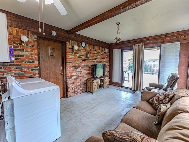 1515 S Reno Ave, El Reno, OK 73036 - living area with brick wall, ceiling fan, beamed ceiling, carpet flooring, and washer and dryer