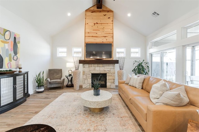 8421 NW 130th Ter, Oklahoma City, OK 73142 - living area with high vaulted ceiling, wood finished floors, a fireplace, plenty of natural light, and beamed ceiling