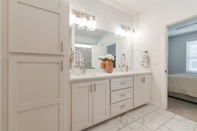 8421 NW 130th Ter, Oklahoma City, OK 73142 - ensuite bathroom featuring double vanity, marble finish floors, and a shower with curtain
