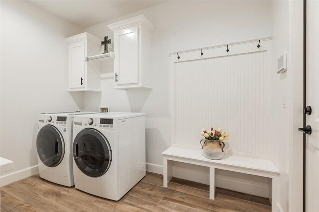 8421 NW 130th Ter, Oklahoma City, OK 73142 - laundry area featuring cabinet space, washing machine and dryer, light wood finished floors, and baseboards