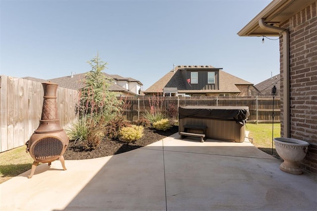 8421 NW 130th Ter, Oklahoma City, OK 73142 - fenced backyard featuring a patio area and a hot tub