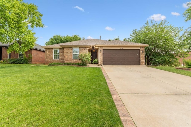 1712 De Vita Rd, Edmond, OK 73003 - view of front of house with a garage, brick siding, a front yard, and driveway