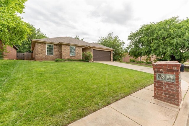 1712 De Vita Rd, Edmond, OK 73003 - view of front of property featuring concrete driveway, a garage, and brick siding