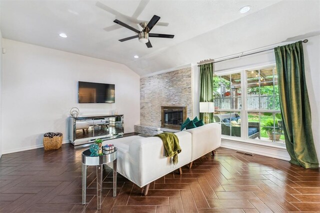 1712 De Vita Rd, Edmond, OK 73003 - living area with vaulted ceiling, ceiling fan, a stone fireplace, recessed lighting, and baseboards