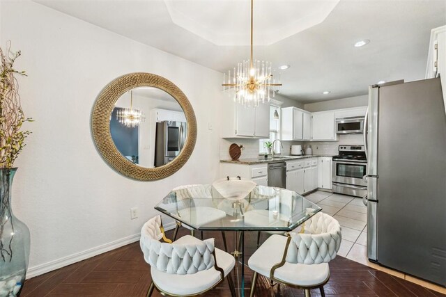 1712 De Vita Rd, Edmond, OK 73003 - dining room featuring a chandelier, baseboards, recessed lighting, and a tray ceiling