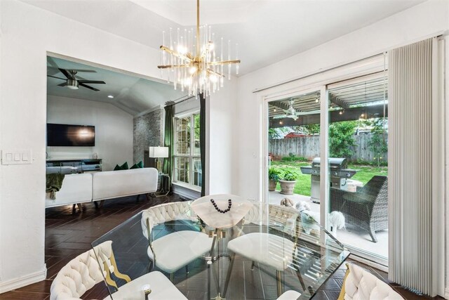 1712 De Vita Rd, Edmond, OK 73003 - dining area with vaulted ceiling, a chandelier, a ceiling fan, and baseboards