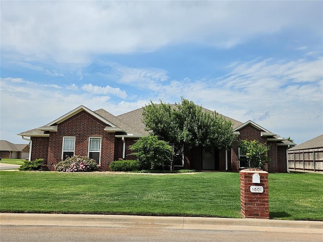 1801 Caribou St, Altus, OK 73521 - view of front of property with brick siding and a front lawn