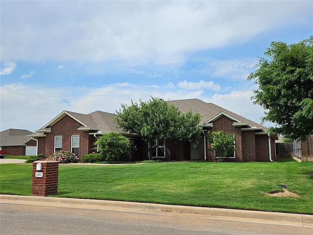1801 Caribou St, Altus, OK 73521 - view of front facade featuring brick siding and roof with shingles