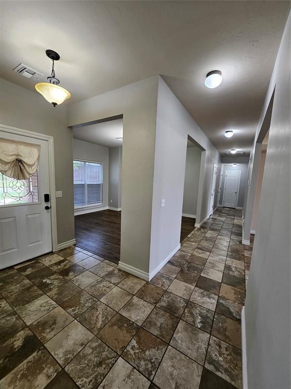 1801 Caribou St, Altus, OK 73521 - entrance foyer with stone tile flooring, baseboards, and plenty of natural light