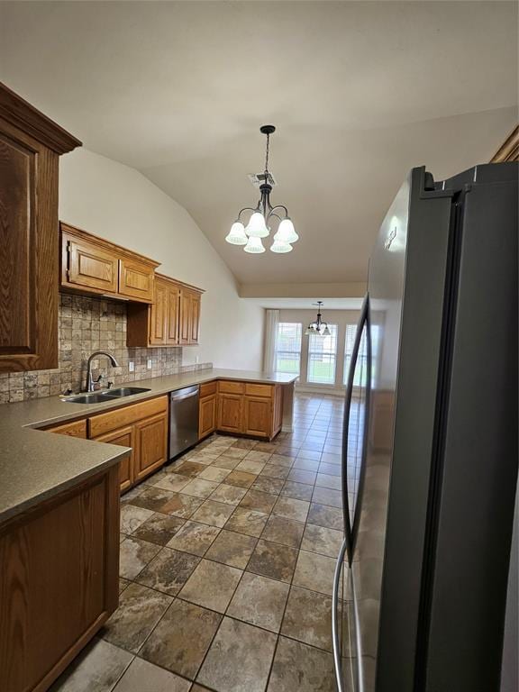 1801 Caribou St, Altus, OK 73521 - kitchen with appliances with stainless steel finishes, a sink, a chandelier, a peninsula, and vaulted ceiling