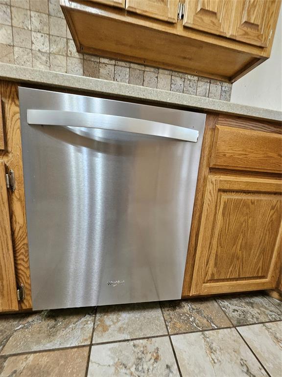 1801 Caribou St, Altus, OK 73521 - kitchen view of dishwasher and brown cabinets