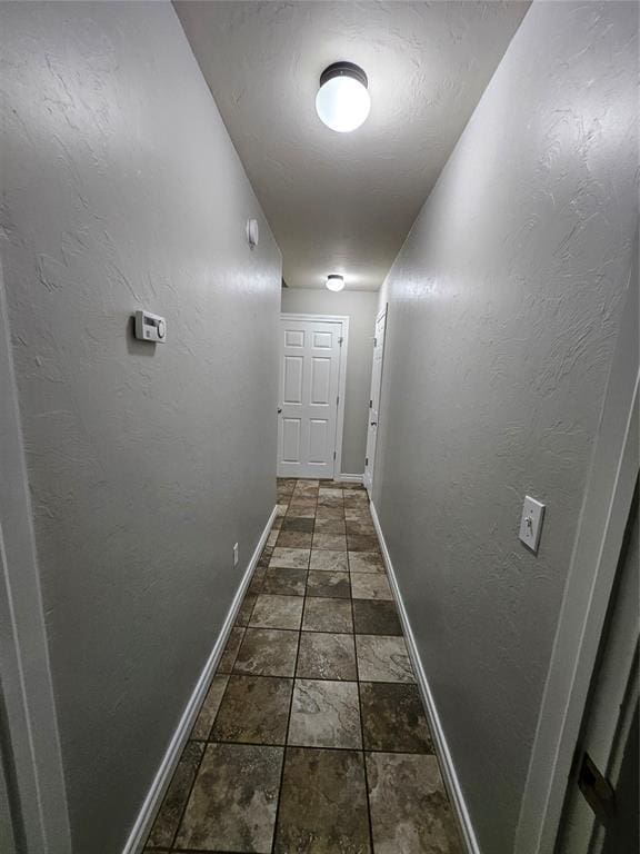 1801 Caribou St, Altus, OK 73521 - hallway featuring baseboards and stone tile floors