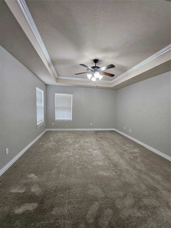 1801 Caribou St, Altus, OK 73521 - carpeted empty room featuring a tray ceiling, a ceiling fan, crown molding, and baseboards