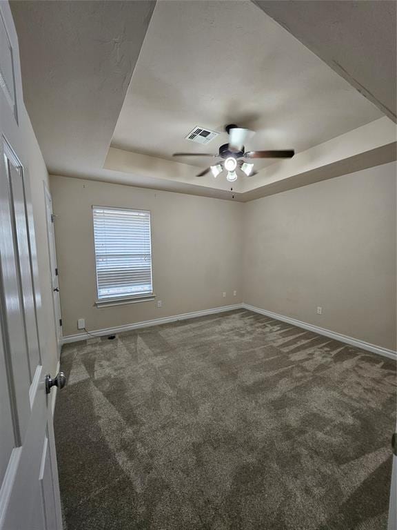1801 Caribou St, Altus, OK 73521 - unfurnished room featuring a raised ceiling, carpet floors, baseboards, and ceiling fan