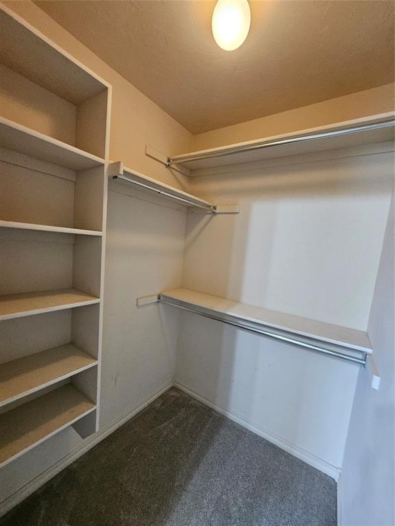 1801 Caribou St, Altus, OK 73521 - walk in closet featuring dark colored carpet