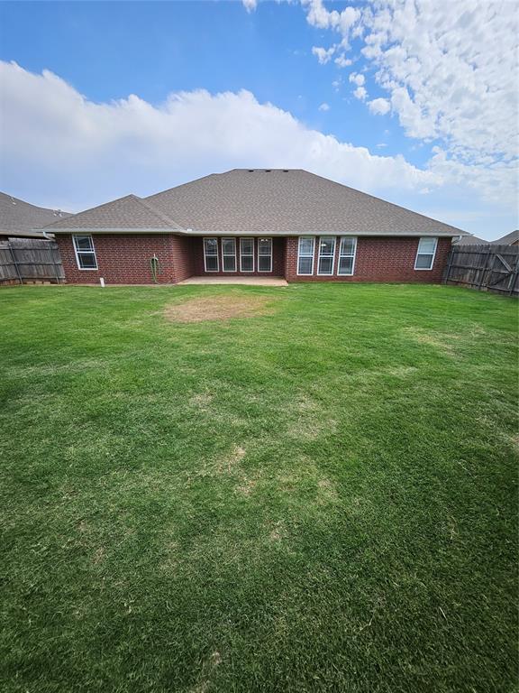 1801 Caribou St, Altus, OK 73521 - rear view of property featuring brick siding