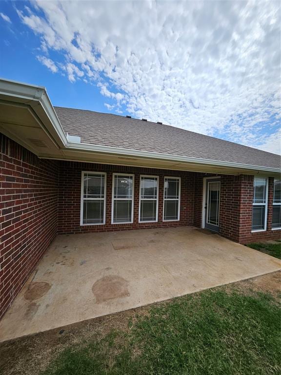 1801 Caribou St, Altus, OK 73521 - back of property featuring brick siding and a patio area