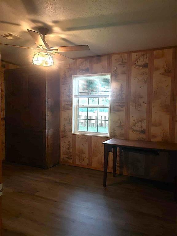 14452 Ns 3630th Rd, Sasakwa, OK 74867 - empty room with ceiling fan, wood finished floors, a textured ceiling, and wood walls