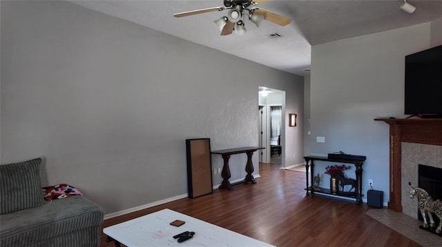 2338 Serenade Dr, Midwest City, OK 73130 - living area with wood finished floors, ceiling fan, a fireplace, and baseboards