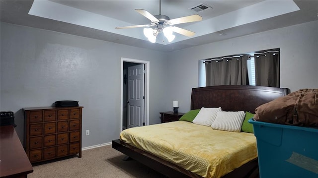 2338 Serenade Dr, Midwest City, OK 73130 - carpeted bedroom with a raised ceiling, ceiling fan, and baseboards