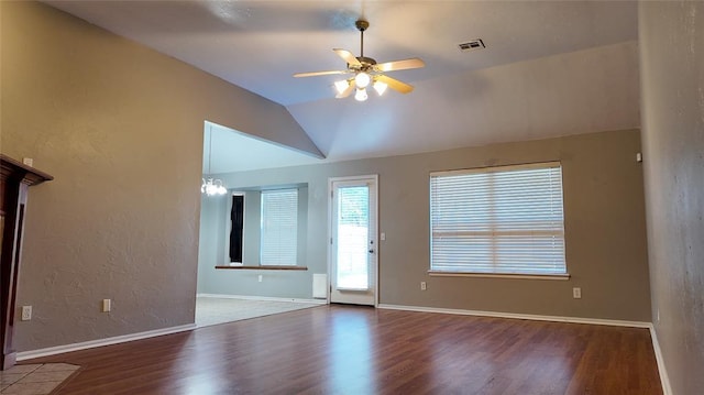 2338 Serenade Dr, Midwest City, OK 73130 - unfurnished living room with wood finished floors, a ceiling fan, vaulted ceiling, and a textured wall