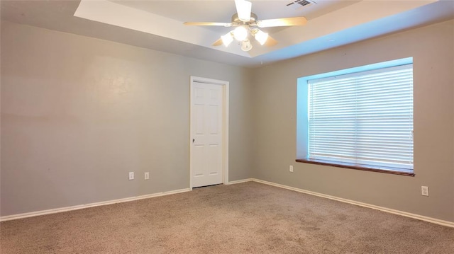 2338 Serenade Dr, Midwest City, OK 73130 - spare room with carpet, a tray ceiling, and a ceiling fan
