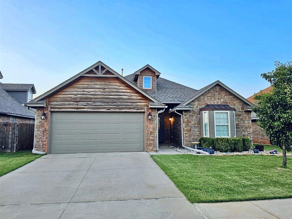 2517 NW 193rd St, Edmond, OK 73012 - view of front of property featuring stone siding, driveway, an attached garage, and roof with shingles