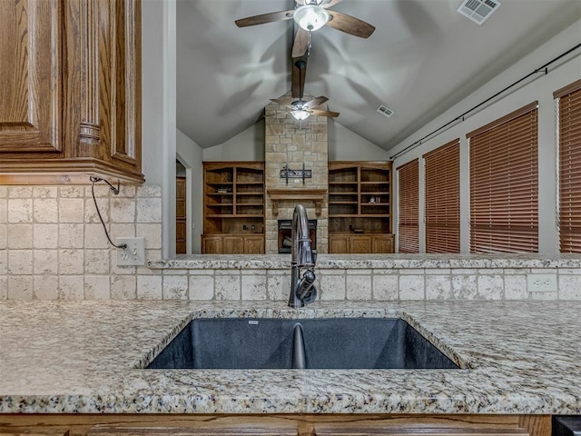 1960 Bermuda Dr, Newcastle, OK 73065 - kitchen with a ceiling fan, a sink, decorative backsplash, light stone counters, and vaulted ceiling