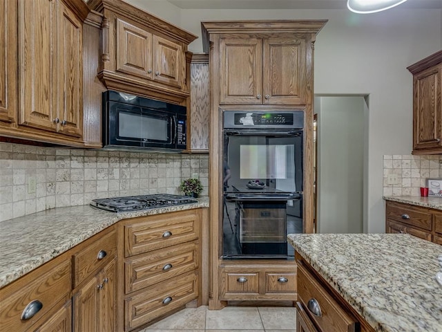1960 Bermuda Dr, Newcastle, OK 73065 - kitchen with black appliances, tasteful backsplash, brown cabinets, light stone countertops, and light tile patterned floors